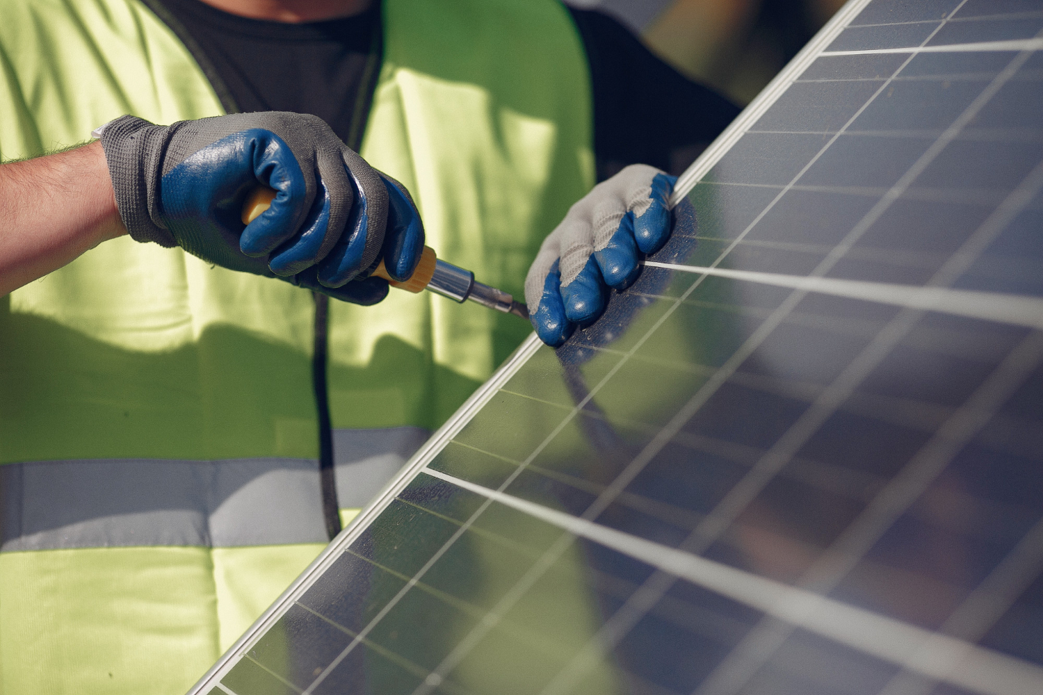 man-with-white-helmet-near-a-solar-panel.jpg